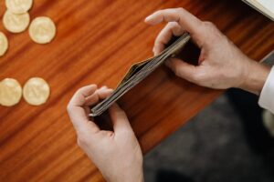 a person's hands holding a stack of money - success