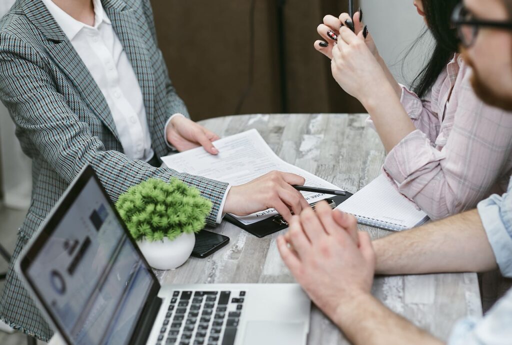 a group of people sitting at a table personal finance