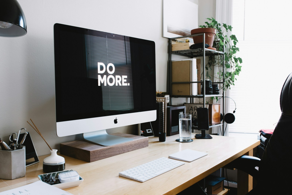 lean minimalist workspace with a laptop and planner representing a focused productivity mindset for personal growth.room