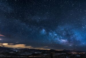milky way over mountain landscape at night